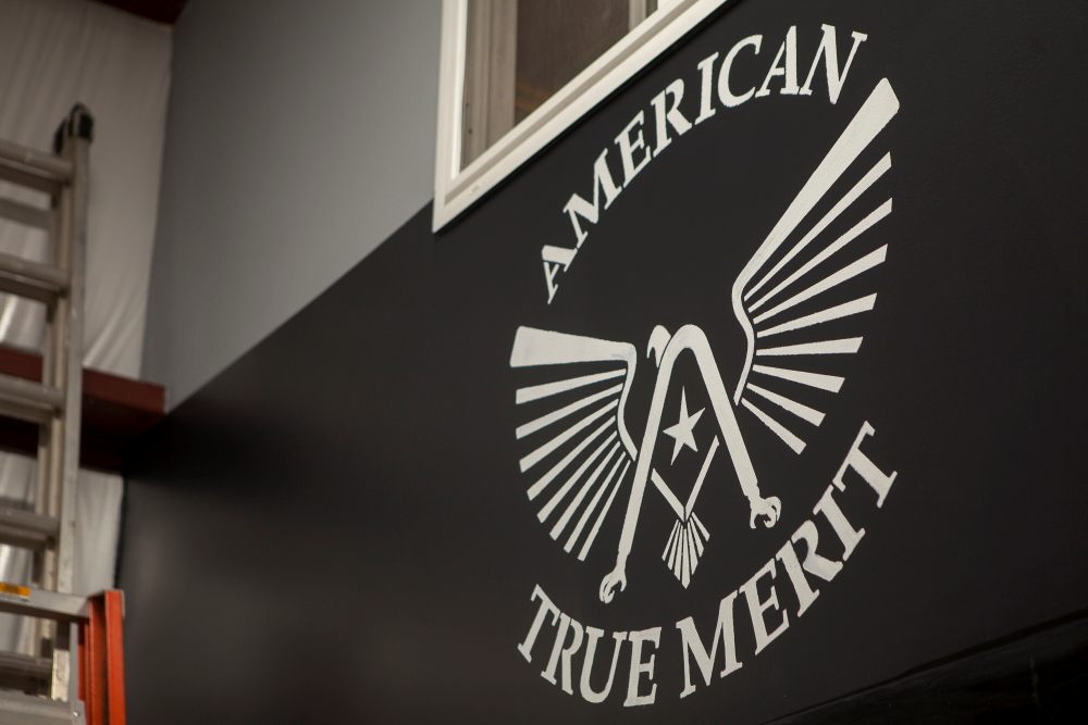 American True Merit eagle logo painted on the shop wall